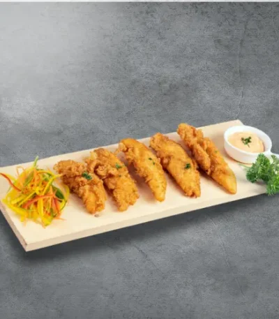 A dish made with bestys chicken fries with salad and sauce