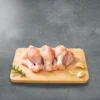 Baby drumsticks on a wooden cutting board