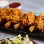 Crispy Chicken Lollipops served with a sauce